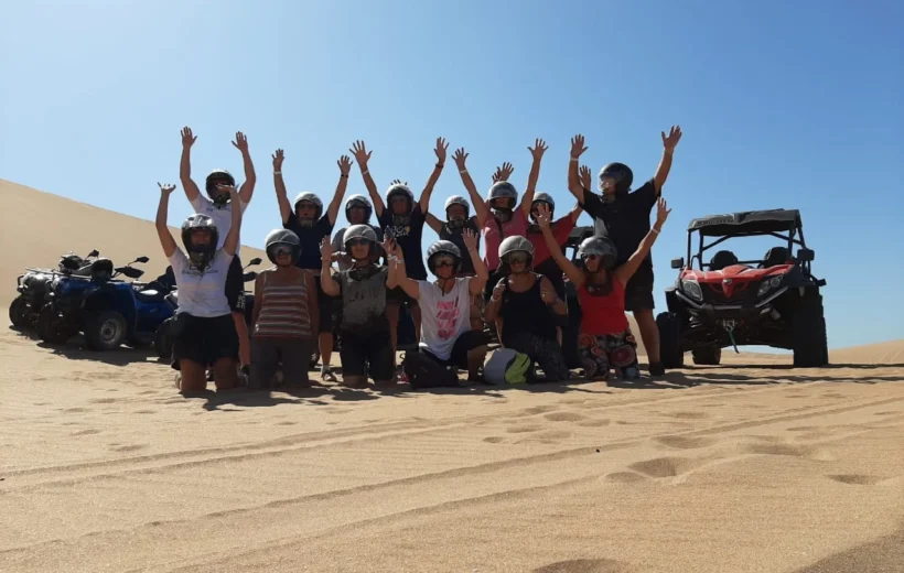 Tourists engaging with locals during a buggy tour in Agadir.