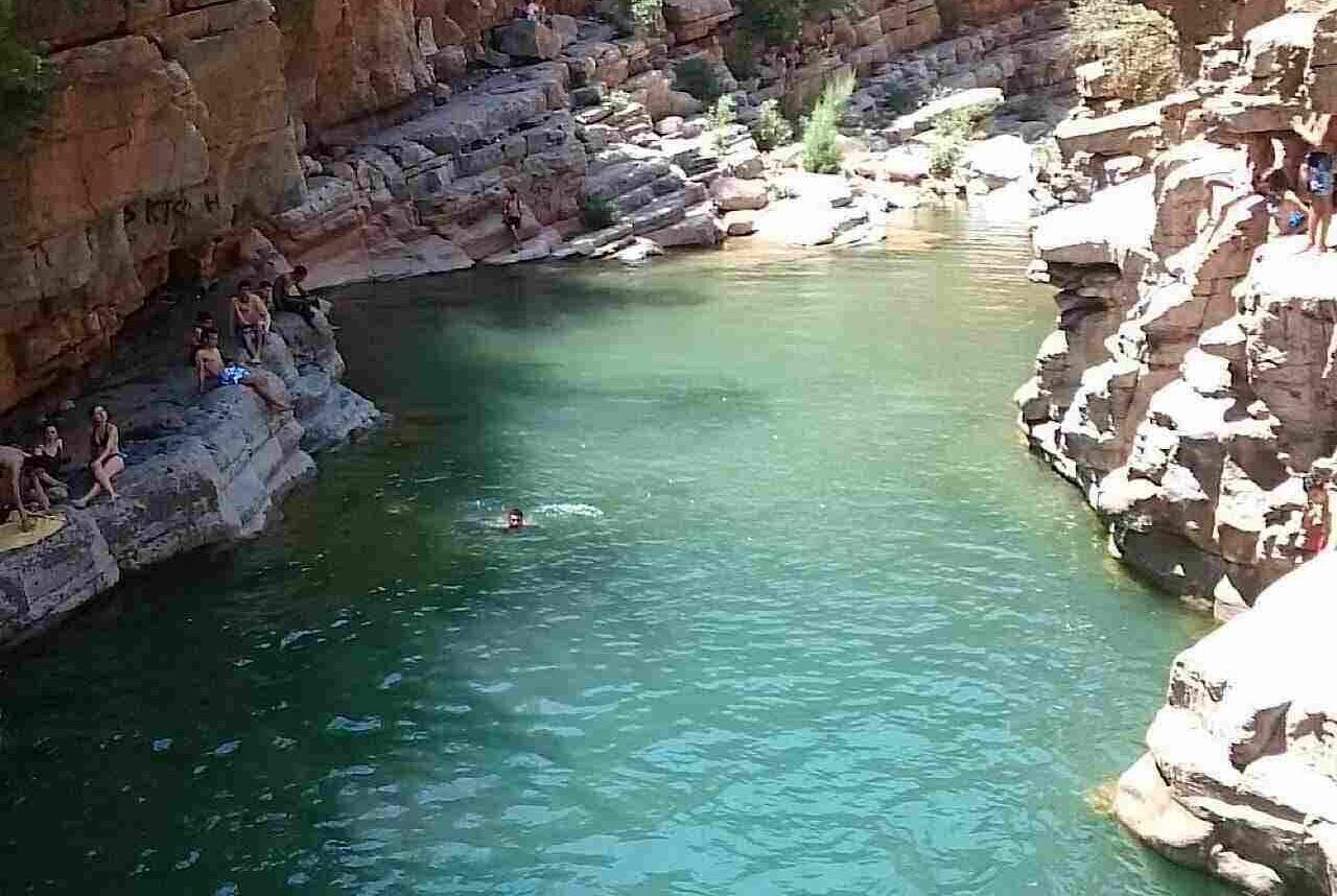 Tourists enjoying the natural pools in Paradise Valley