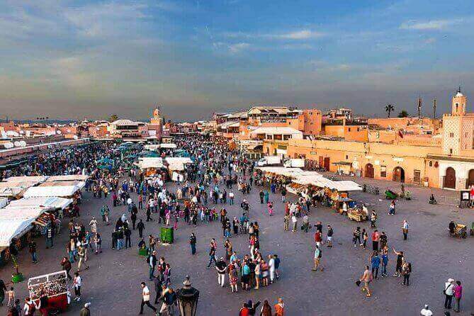 Travelers enjoying a Taghazout day trip to Marrakech, exploring vibrant markets.